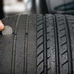close up of worn car tyre tread showing low tread depth